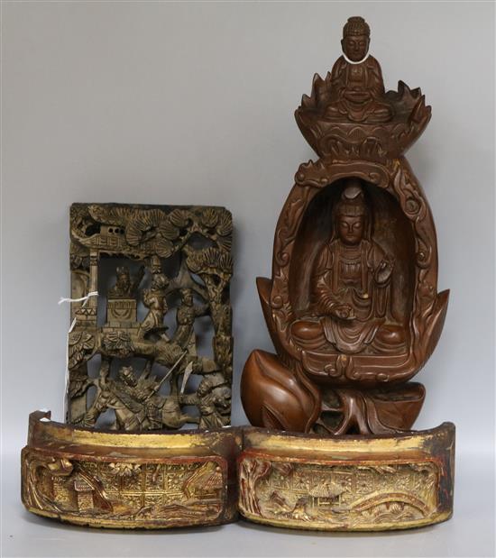 A Chinese carved wood figure of Guanyin and three similar panels